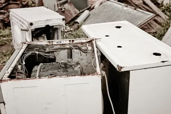 Removing old household appliances from a home.