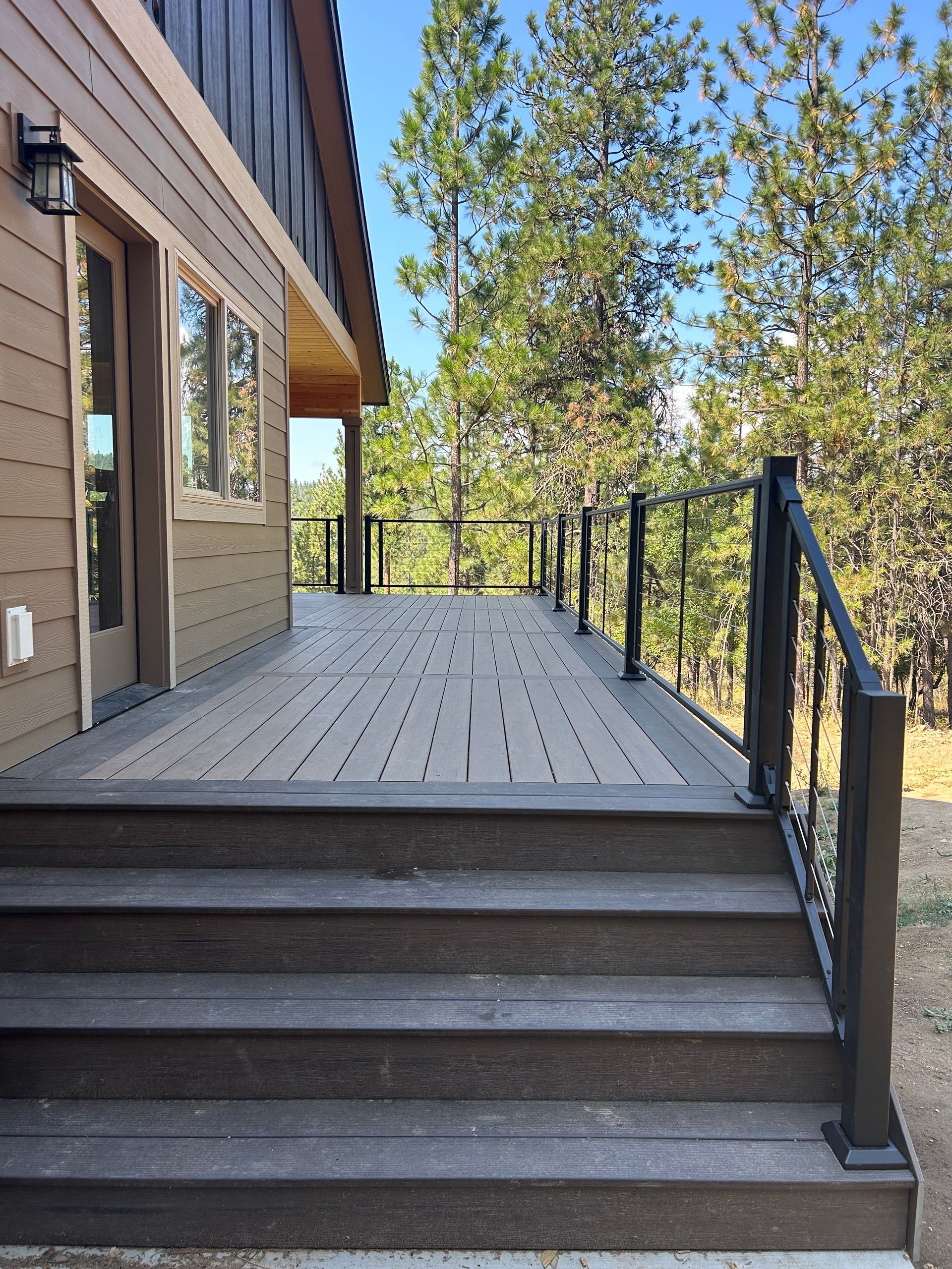 A wooden deck with stairs leading up to it