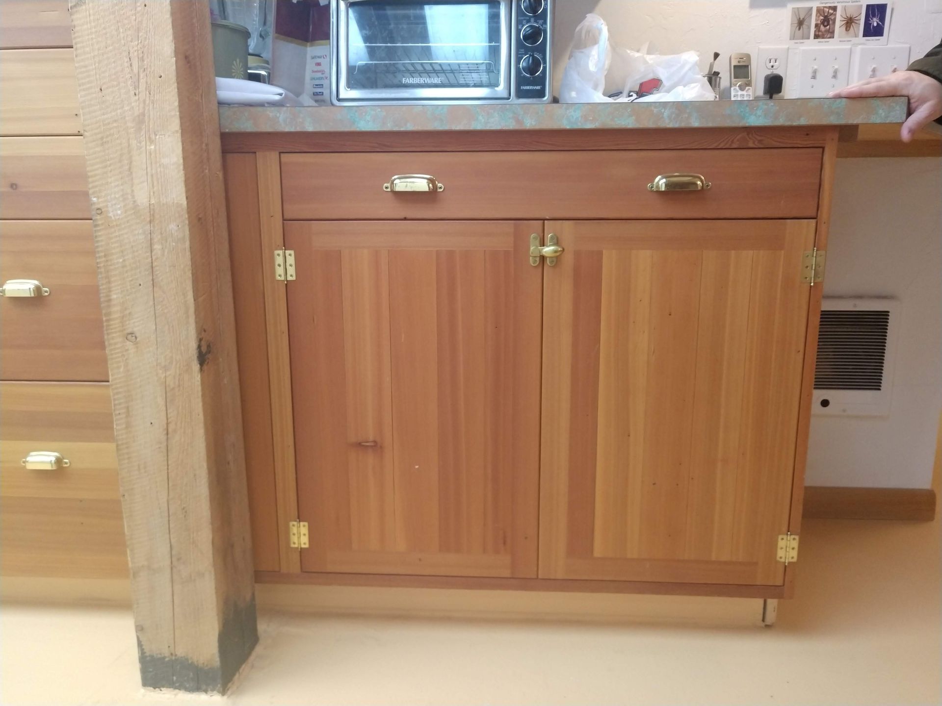 A kitchen with wooden cabinets and drawers 