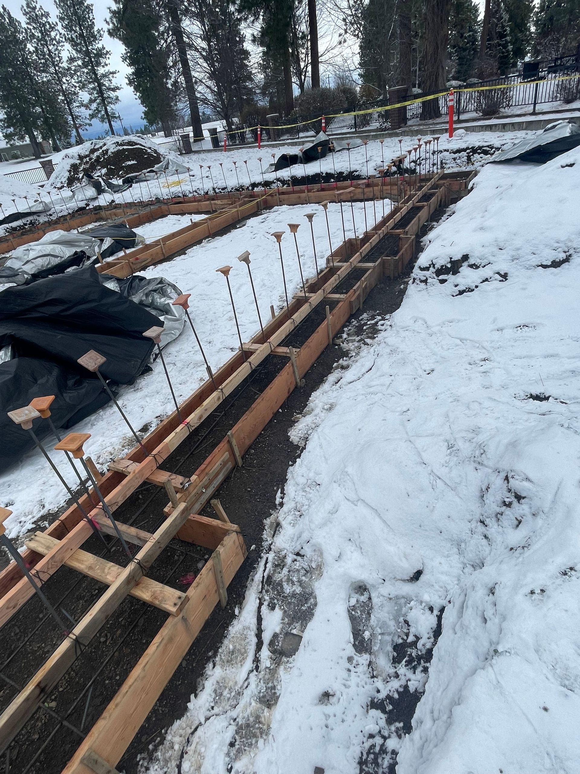 There is a lot of snow on the ground and a lot of wooden boards in the snow.