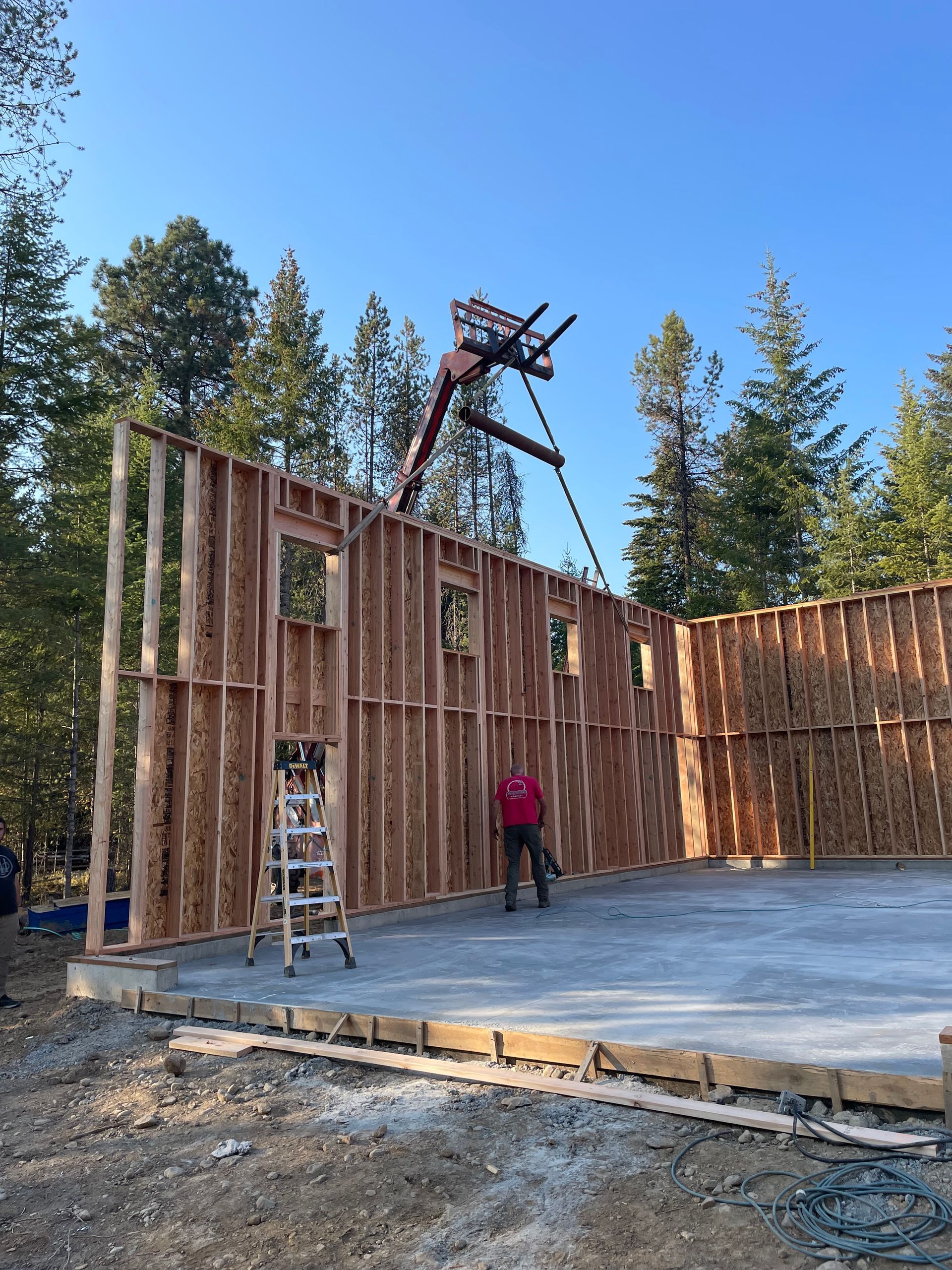 A man is standing in front of a building under construction.
