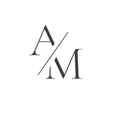 Pale yellow “A/M” monogram with a diagonal slash on a white background