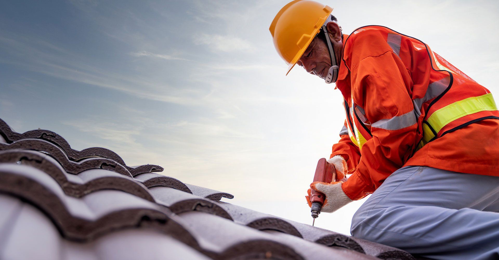 A person doing roofing services in Redding, CA