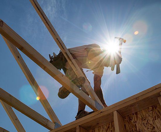 Worker At The Top Of Roof — Gerber, CA — Hinkle Roofing & Construction Worker At The Top Of Roof — Gerber, CA — Hinkle Roofing & Construction