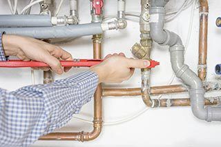 Local plumber tightening pipe fittings
