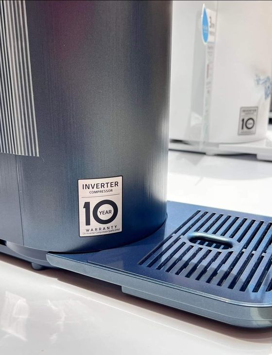 Blue appliance with a 10-year warranty sticker, set on a drip tray.