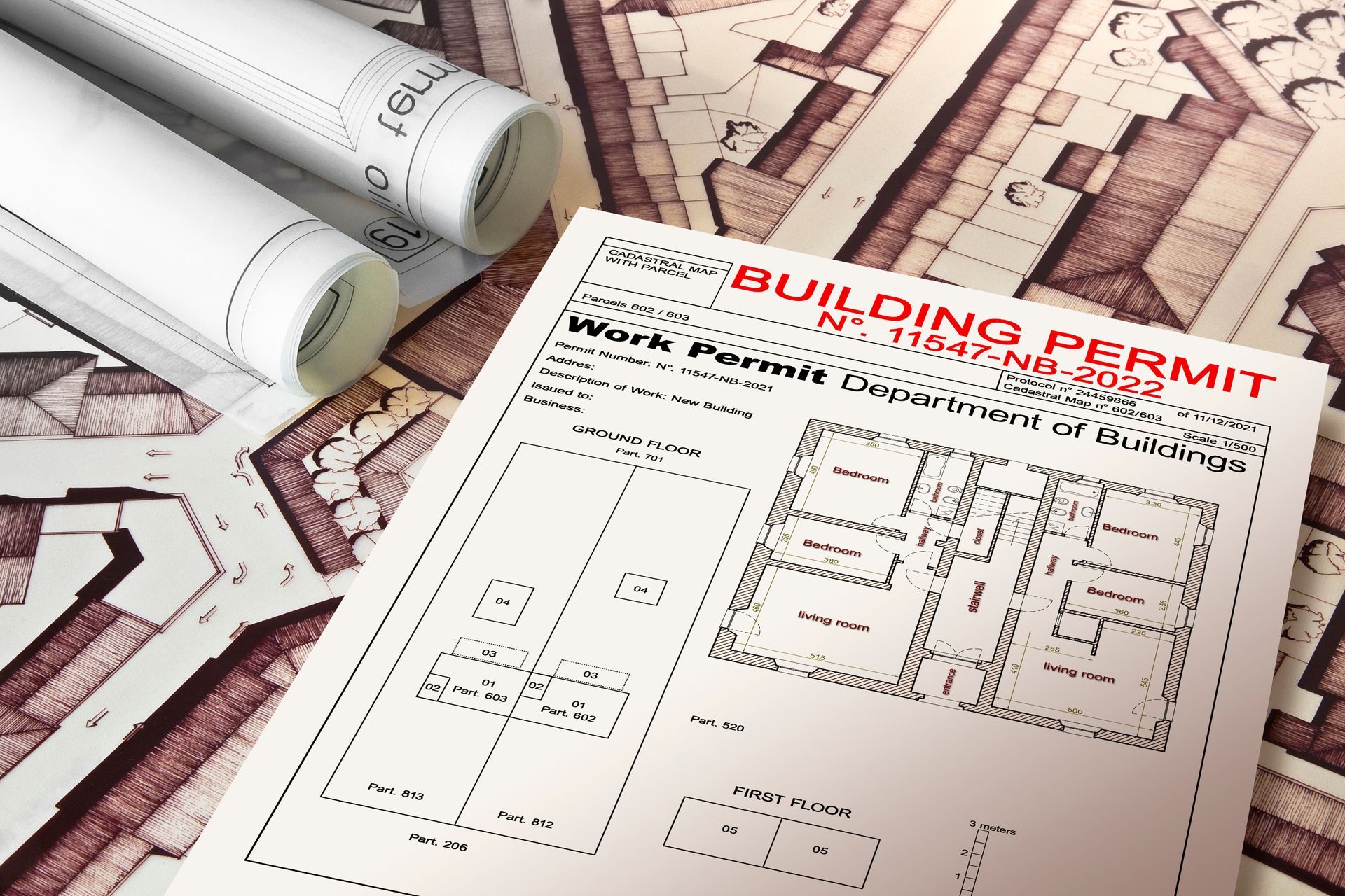 Building permit blueprints and rolled architectural plans on a desk
