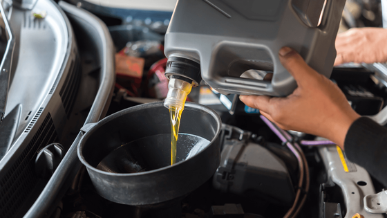a mechanic doing an oil change
