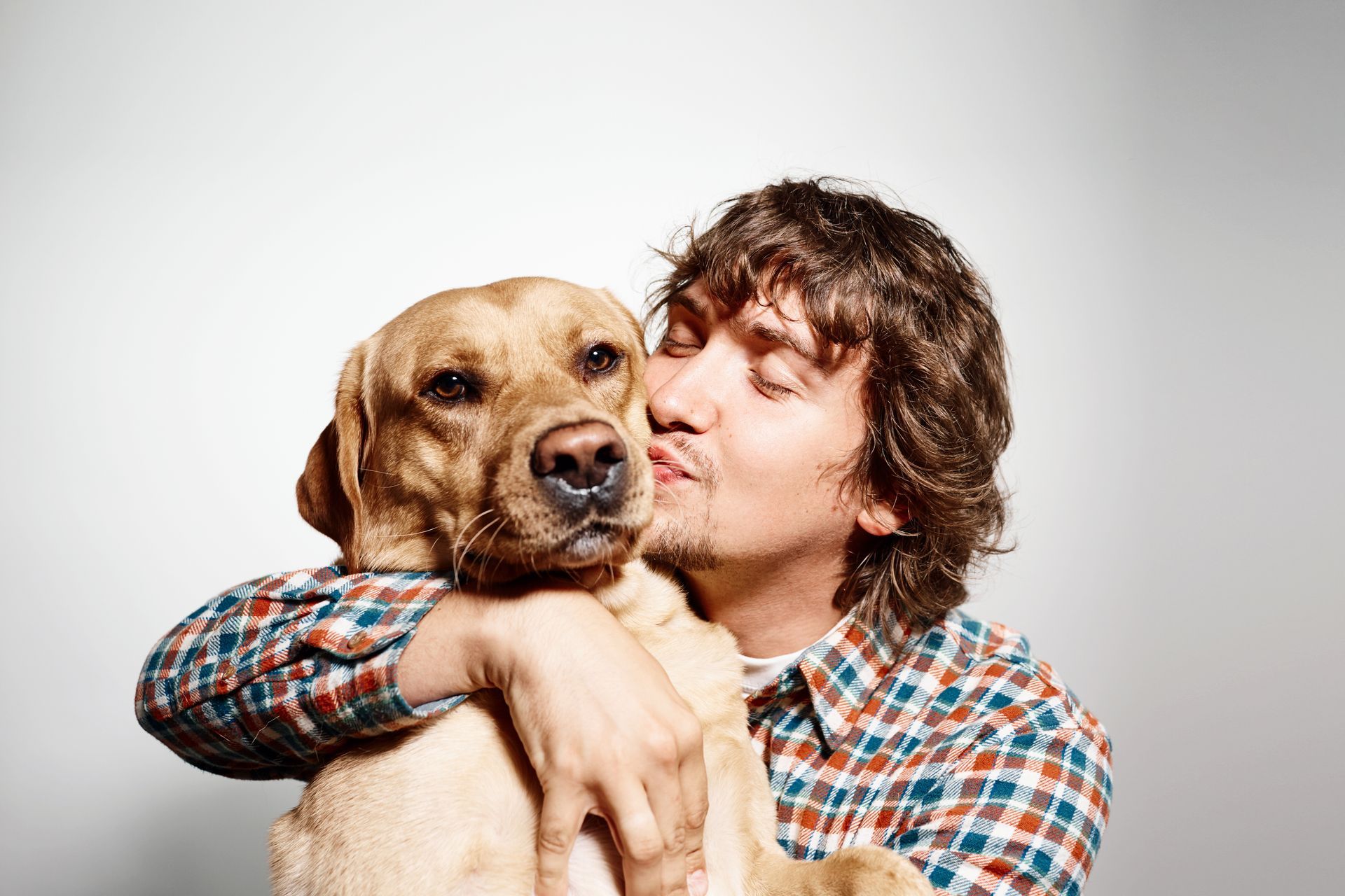 pet owner hugging dog