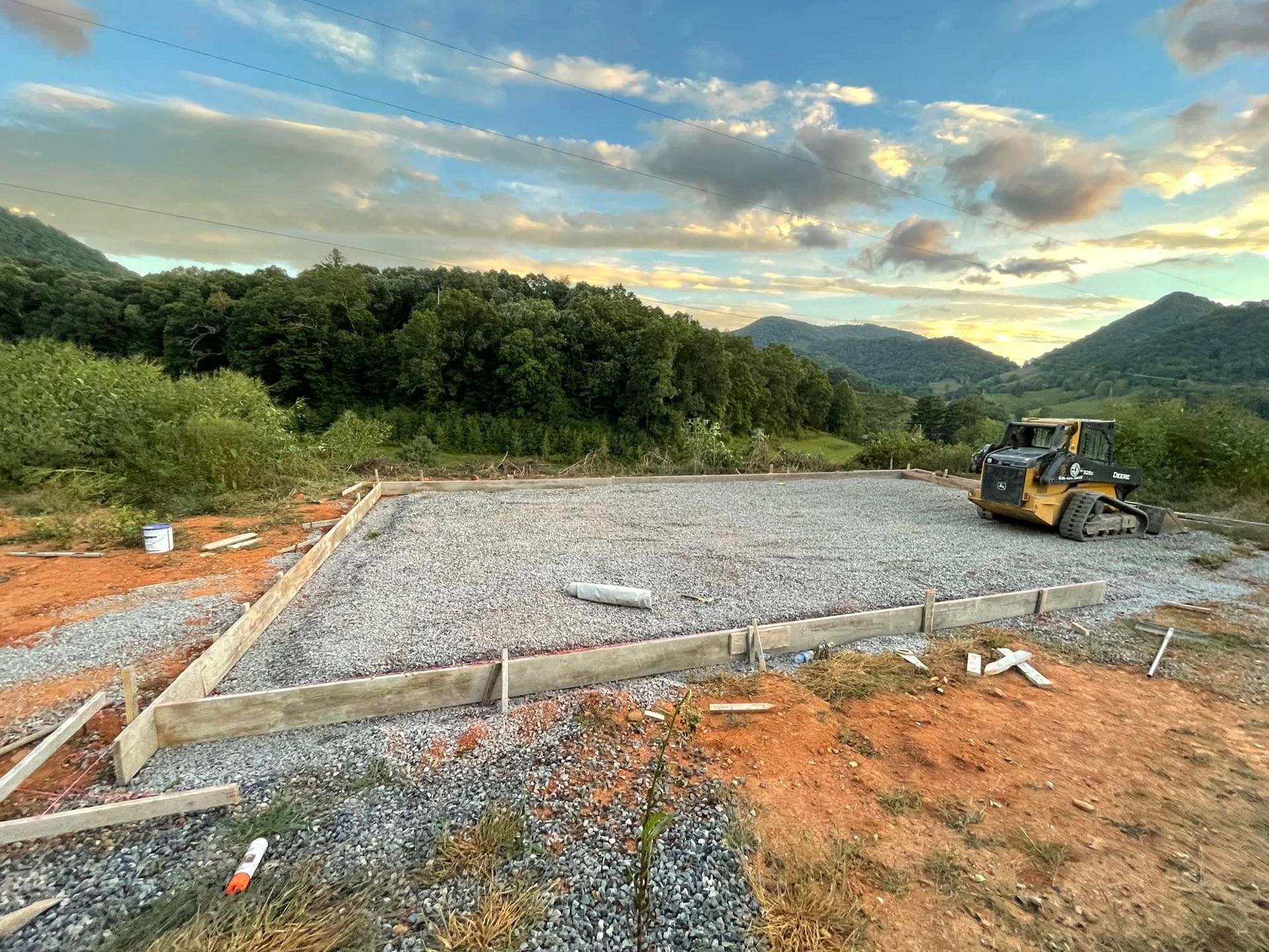 A group of construction workers are working on a concrete walkway.