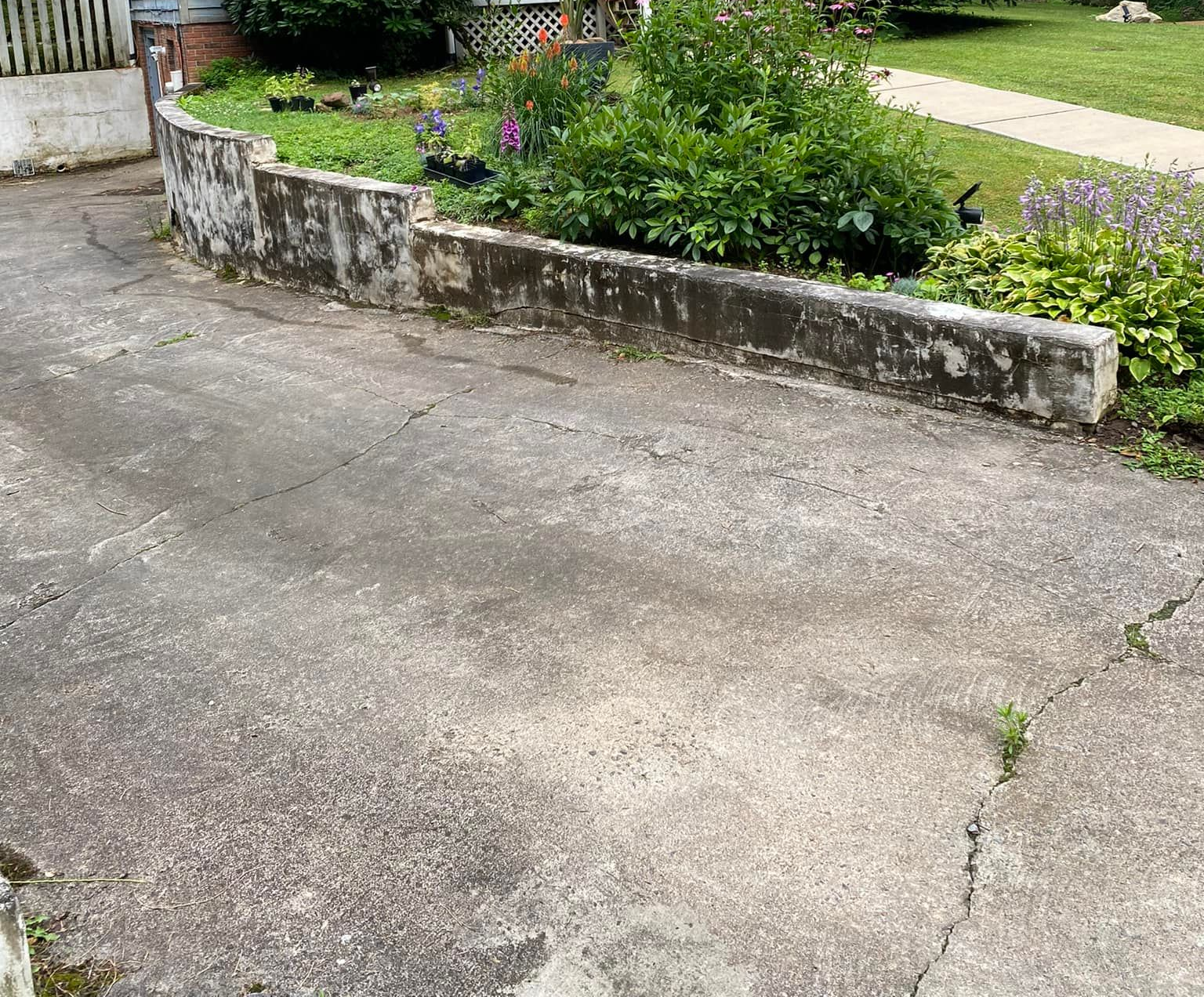 A group of construction workers are working on a concrete walkway.