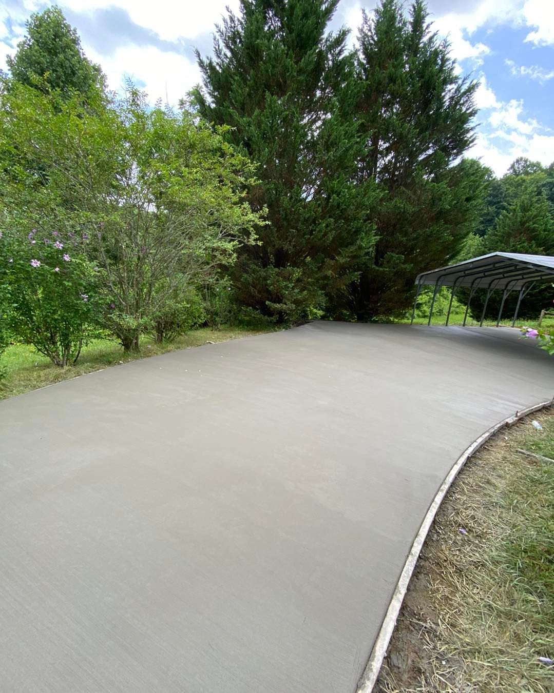 A group of construction workers are working on a concrete walkway.