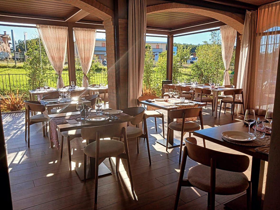 Apparecchiare la tavola in un ambiente da ristorante con bicchieri da vino, piatti e tovaglioli.