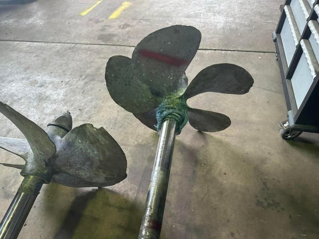 Two Propellers Are Sitting on a Concrete Floor in a Garage — ElectroMech Machine in Woolner, NT