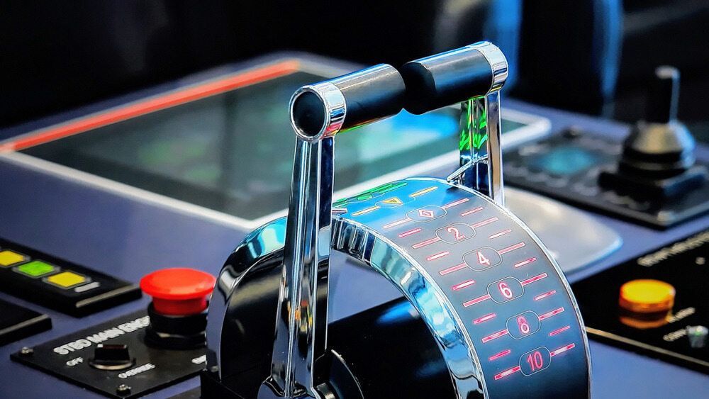 Chrome engine control lever with illuminated speed indicators, buttons, and a touchscreen display — ElectroMech Machine in Woolner, NT