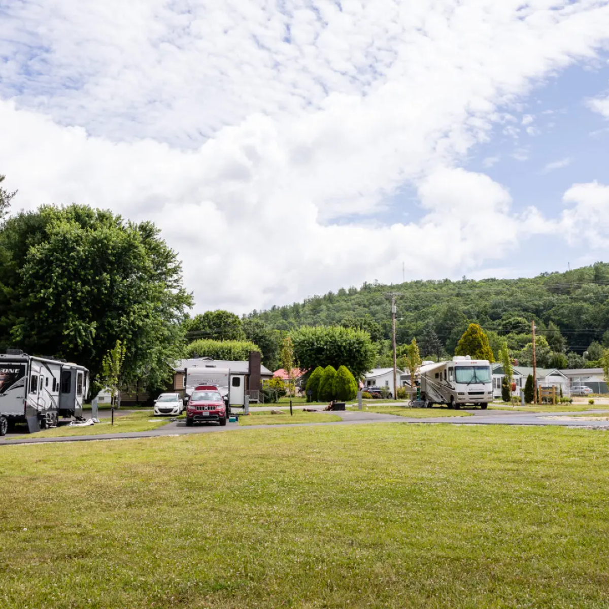 A lot of rv 's are parked in a grassy field