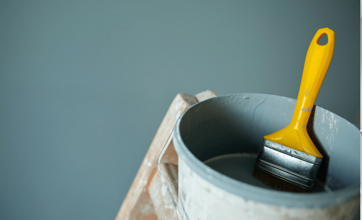 blue grey paint bucket on a ladder. 
