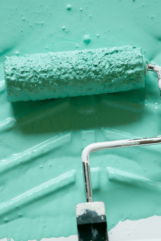 paint tray and roller with teal colored paint