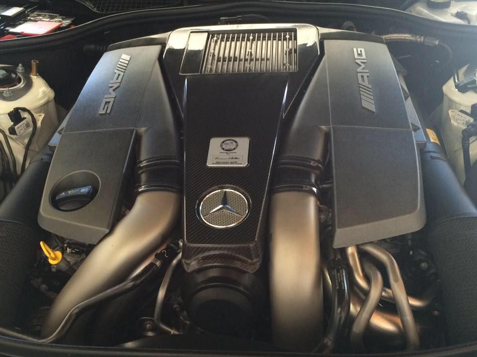 Mercedes-AMG engine with black covers, silver intake tubes, and the AMG logo.
