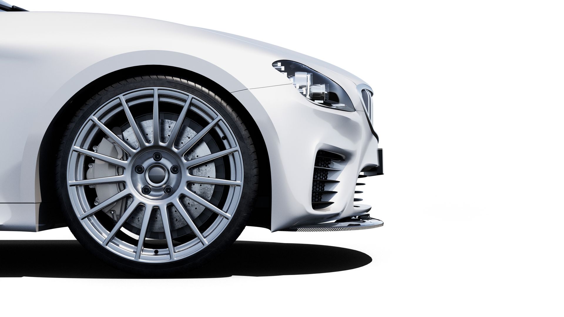 White sports car front quarter view, silver wheel, black shadow.