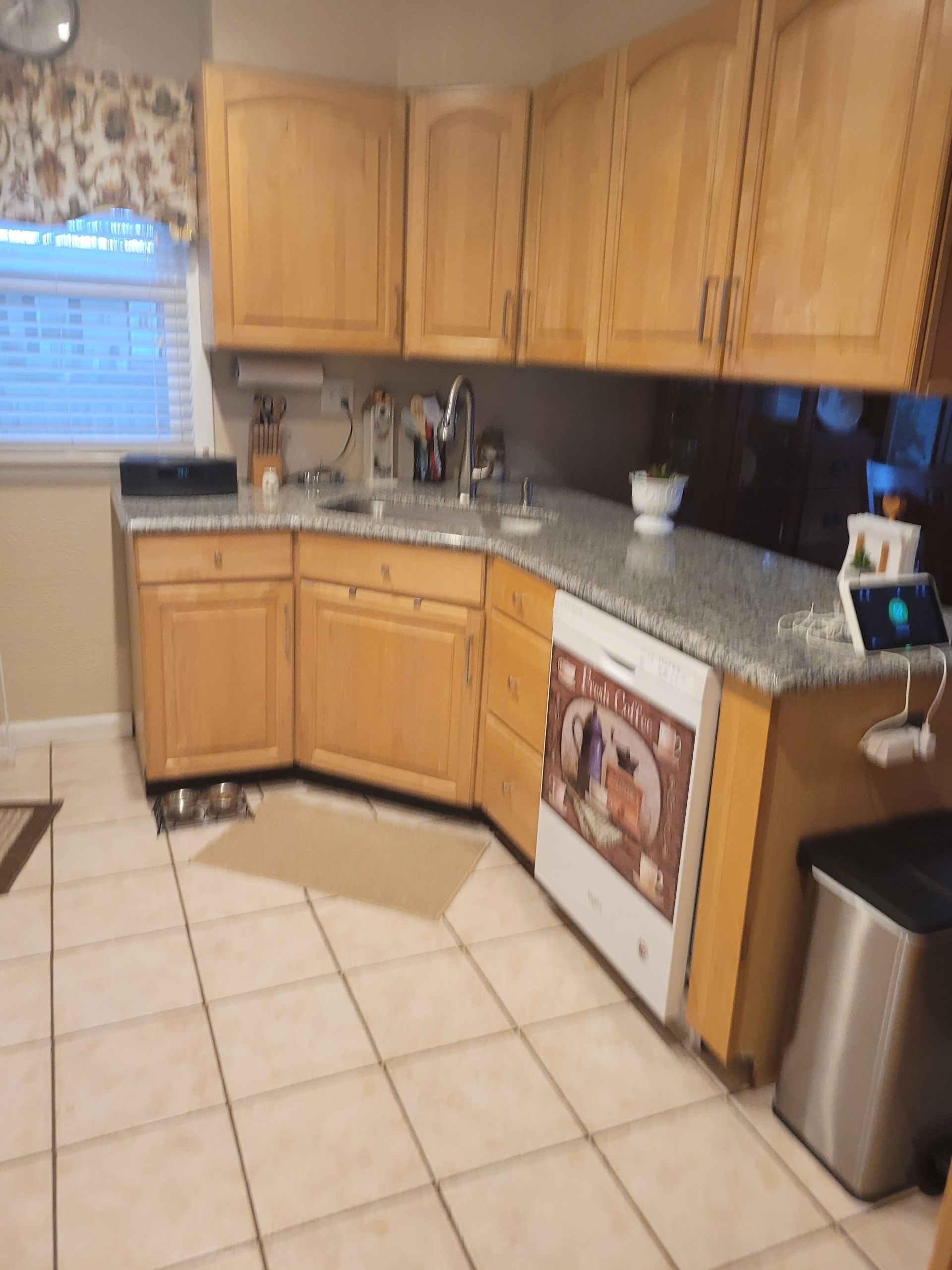 A kitchen with wooden cabinets and granite counter tops