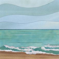 Ocean scene with blue-green water, wavy white foam on a sandy shore, and pale blue sky.