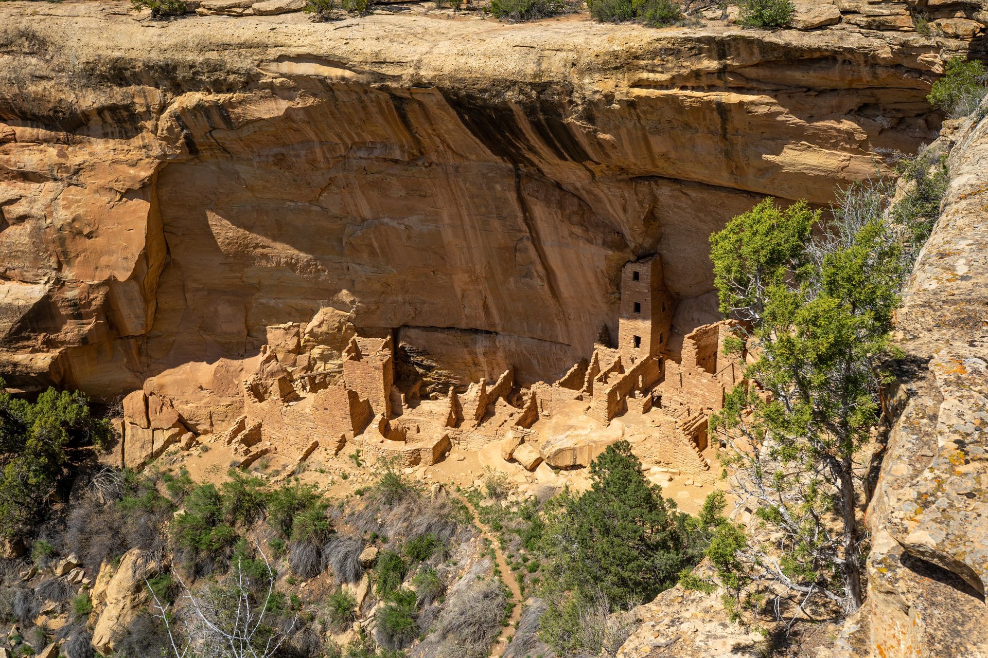 An aerial view of a house carved into the side of a cliff.