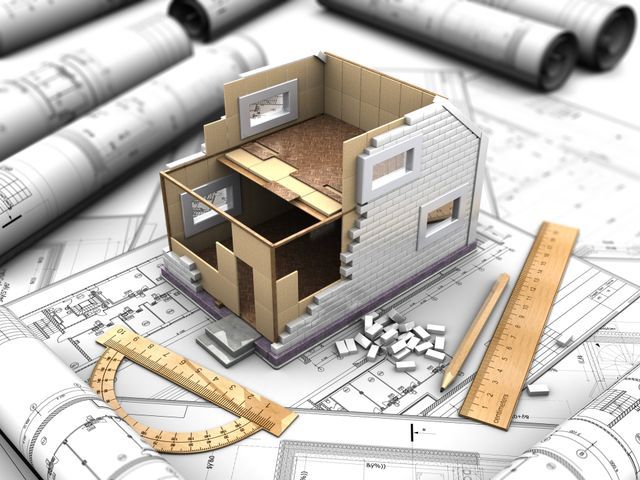 3D house model on architectural blueprints with rulers and drafting tools