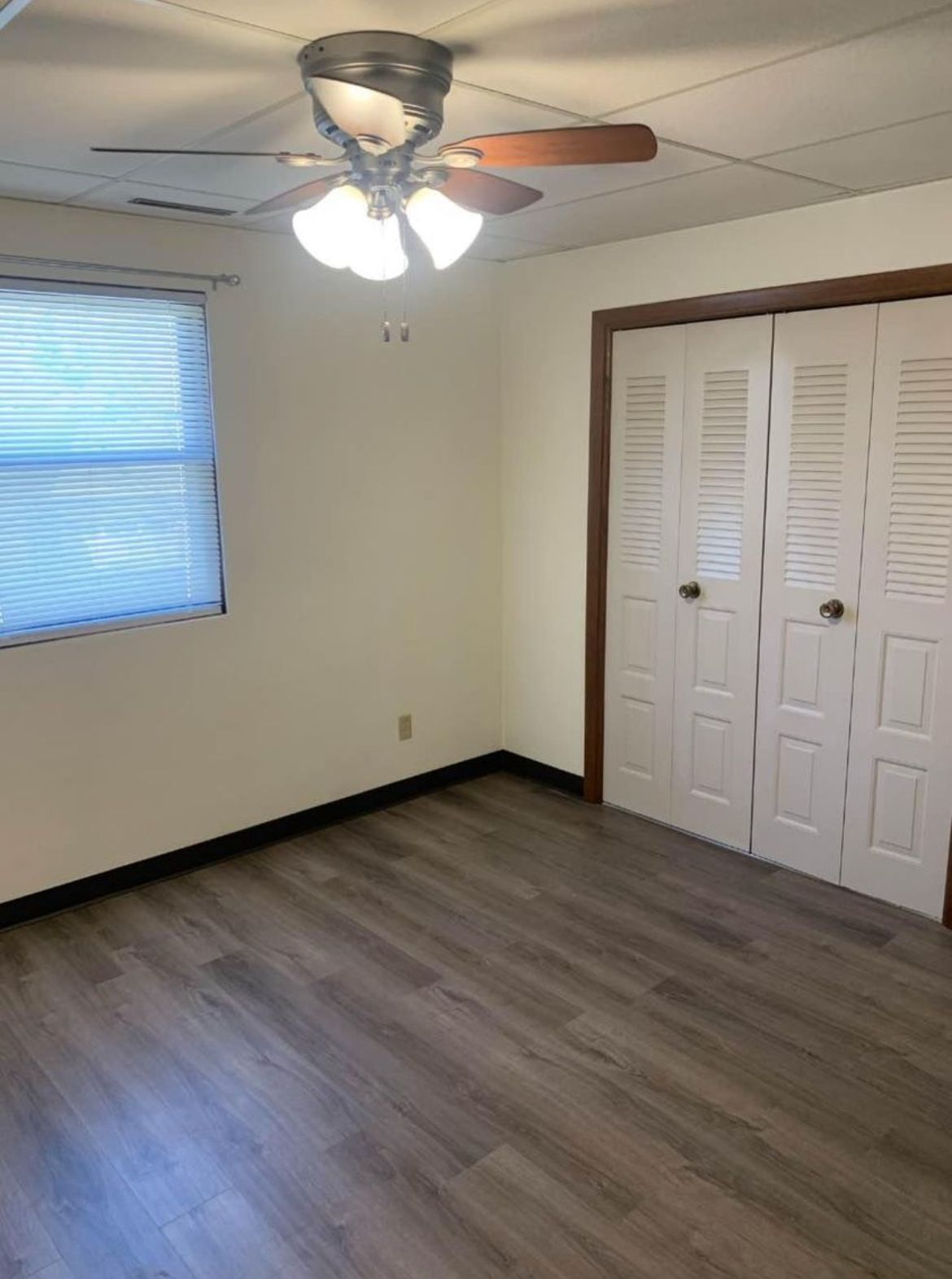 There is a ceiling fan in the room and a window.
