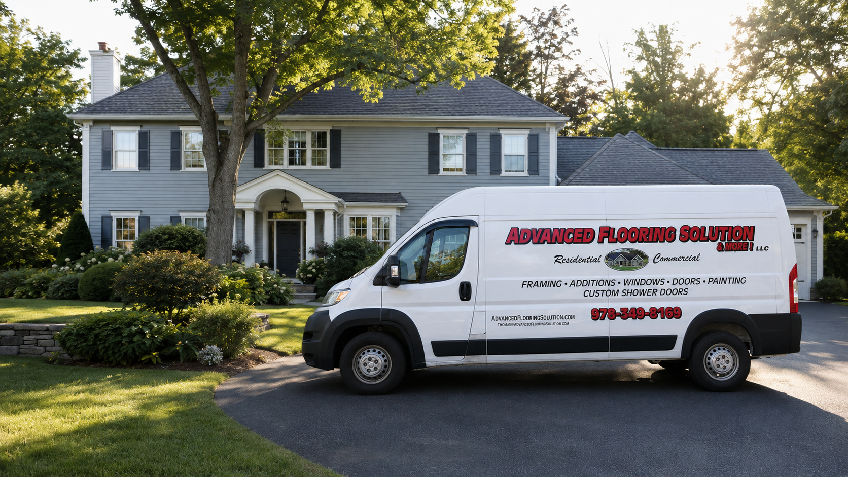 White service van parked in front of a blue house with trees and shrubs in the yard
