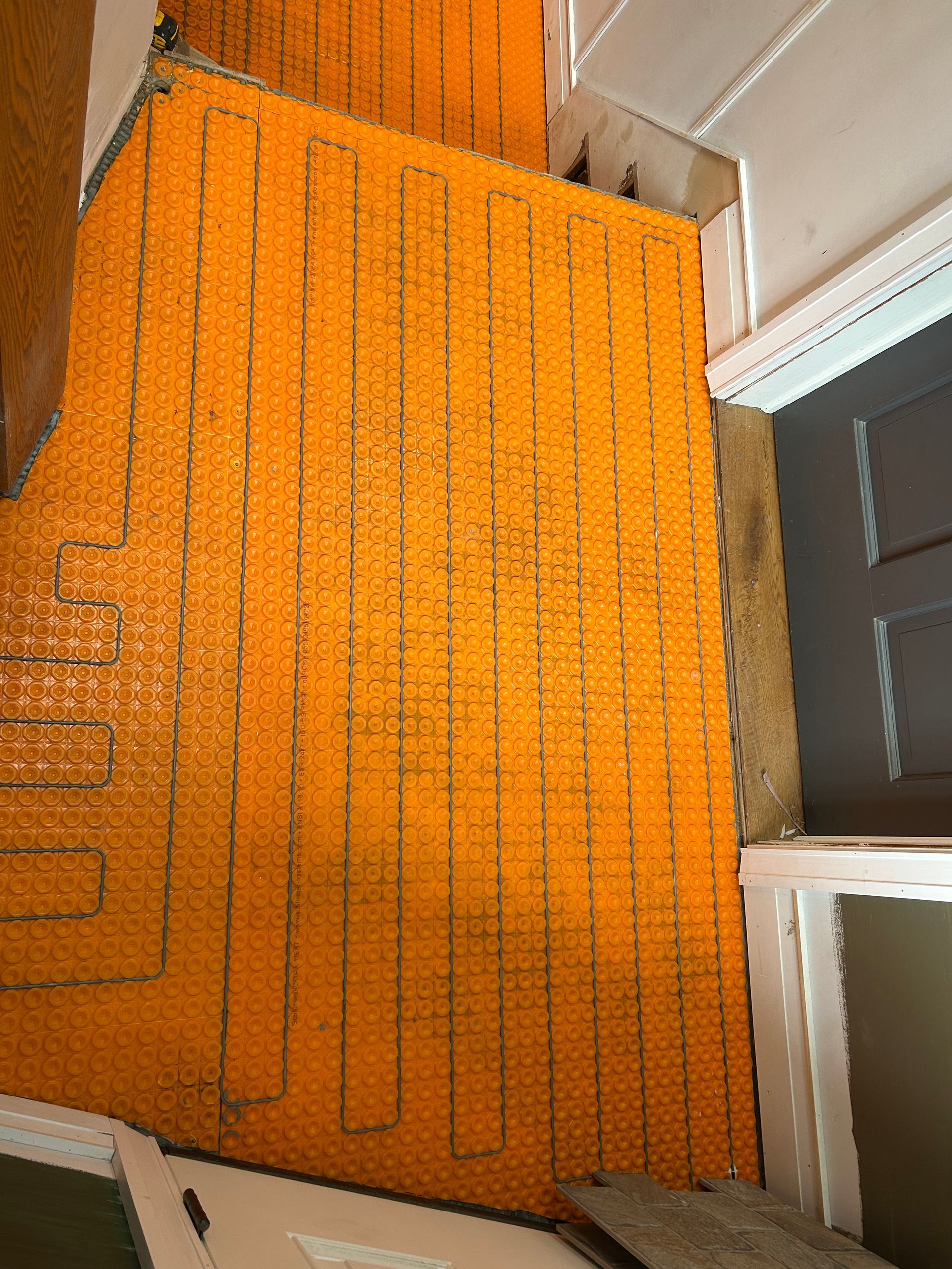 Orange carpeted staircase and hallway with a white banister and window blinds