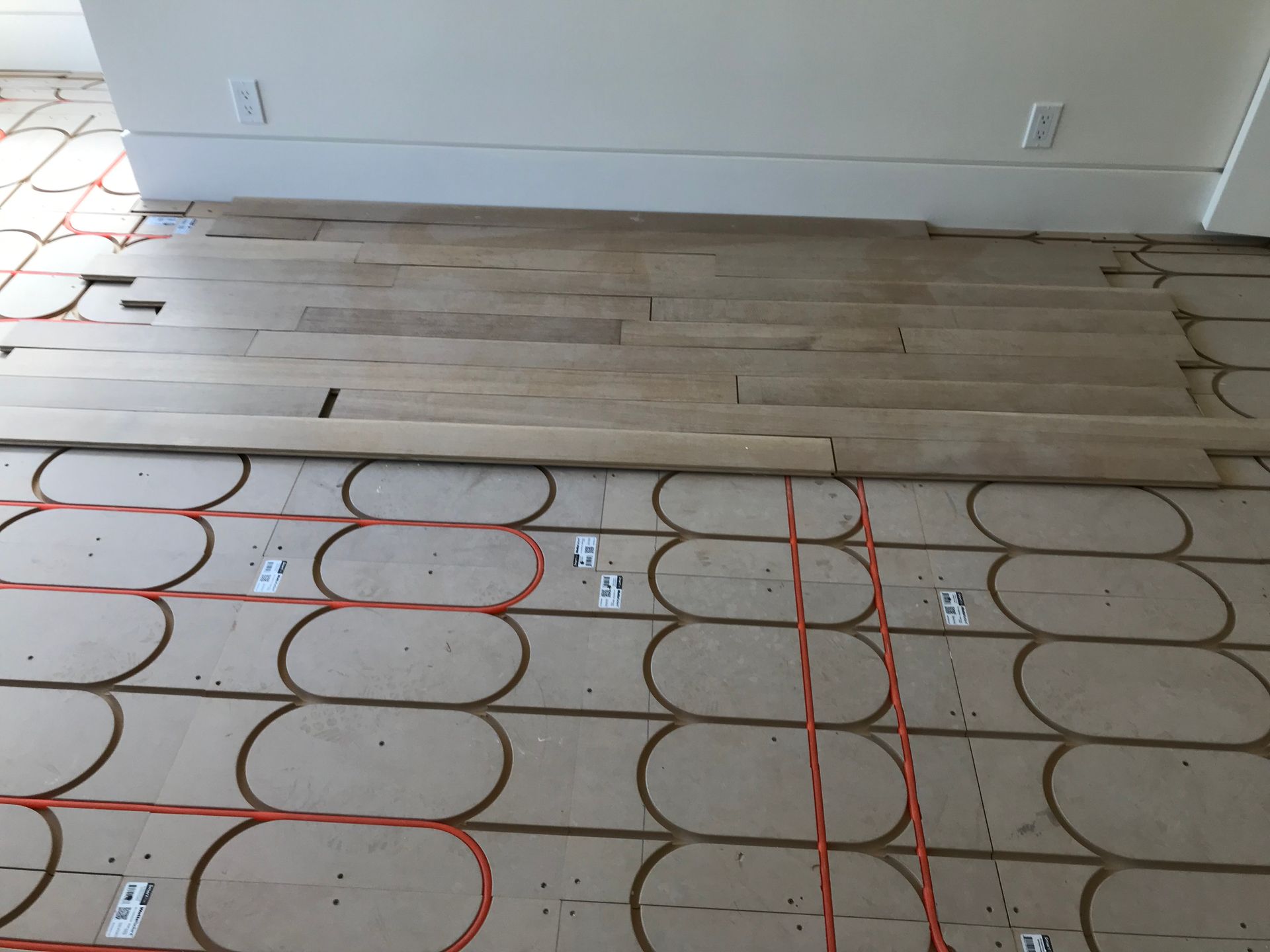 Floor under construction with cardboard floor protection and red grid markings in a room