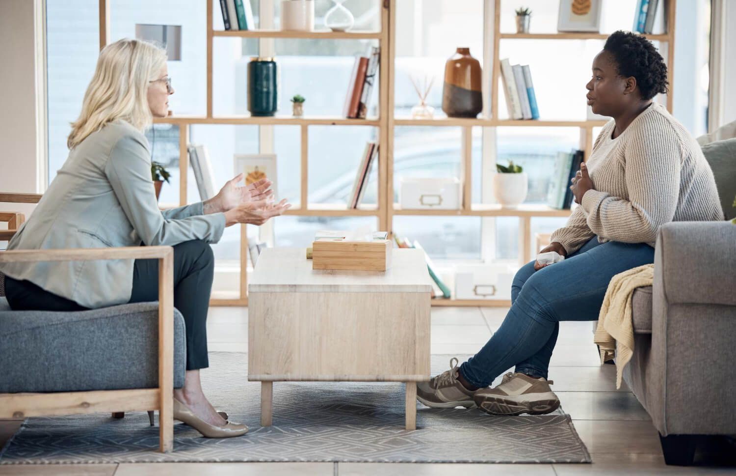 Licensed therapist conducting Internal Family Systems therapy session with client in comfortable, modern therapy office setting at Live Consciously PLLC