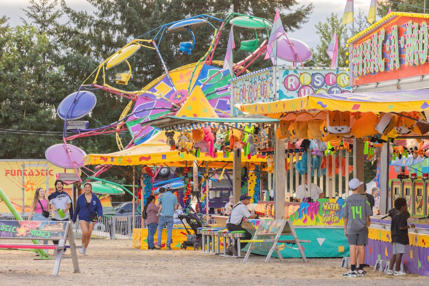 A group of people are standing in front of a carnival.