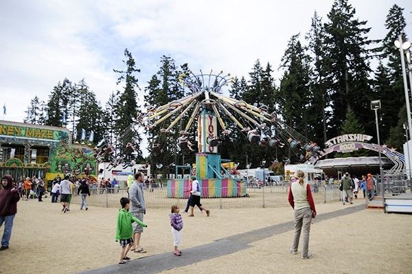 A group of people are walking around an amusement park