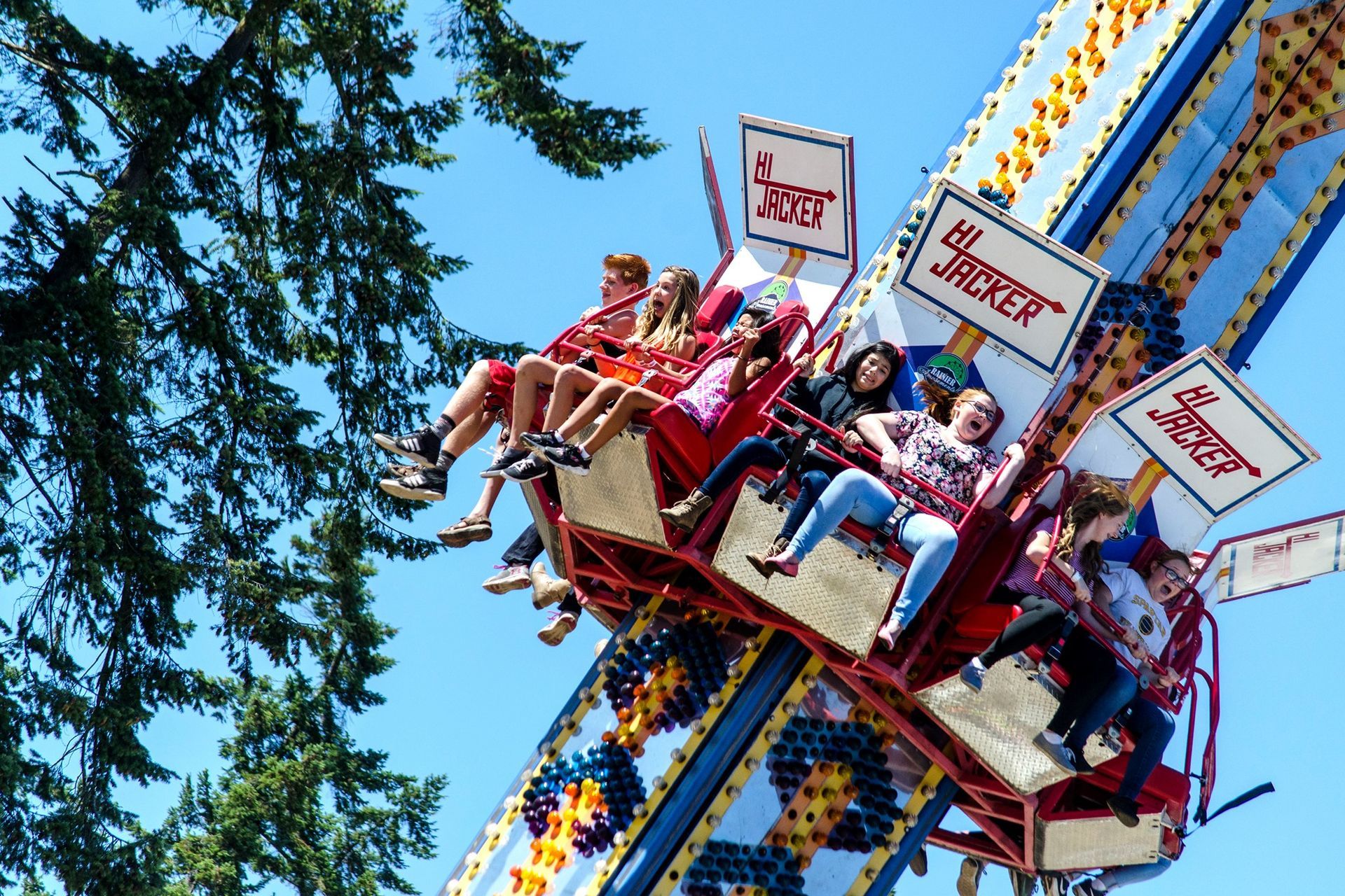 A group of people are riding a carnival ride called the twister
