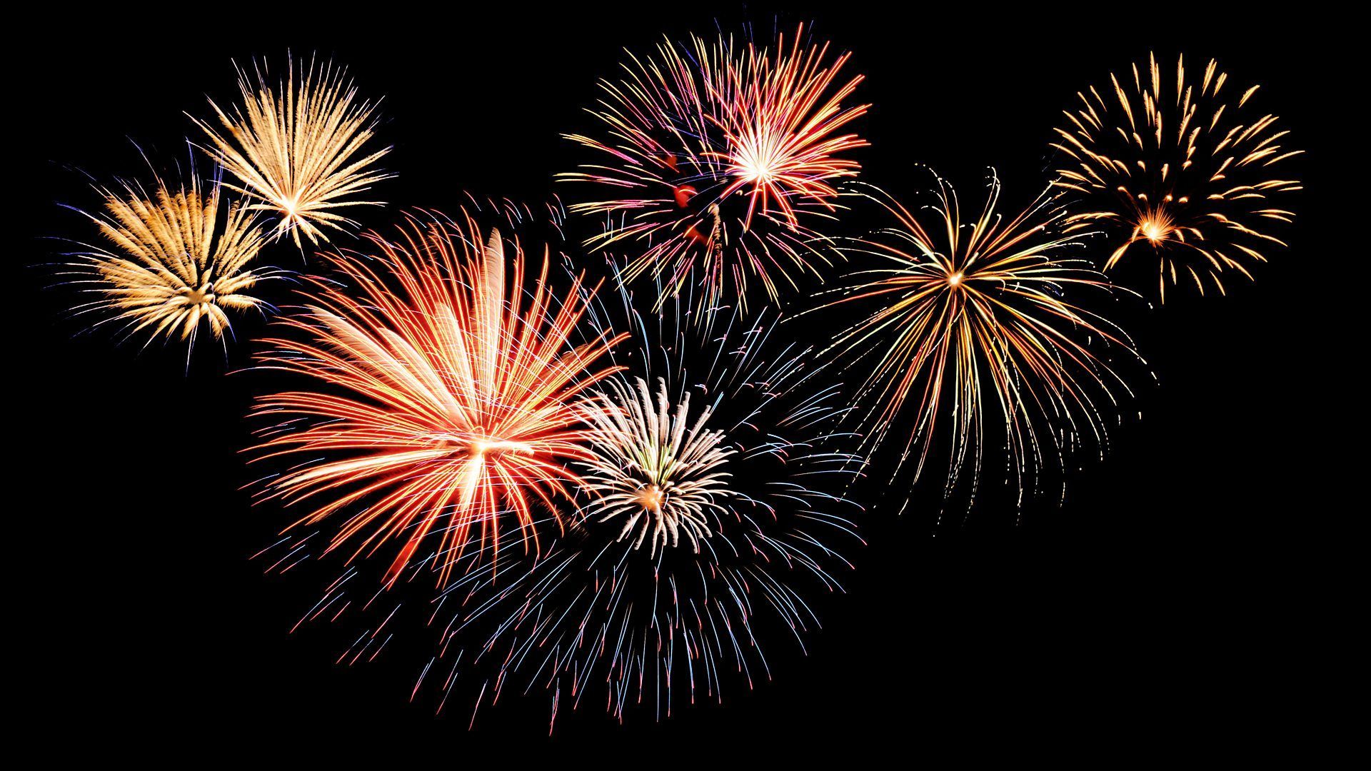 A bunch of fireworks are exploding in the night sky.