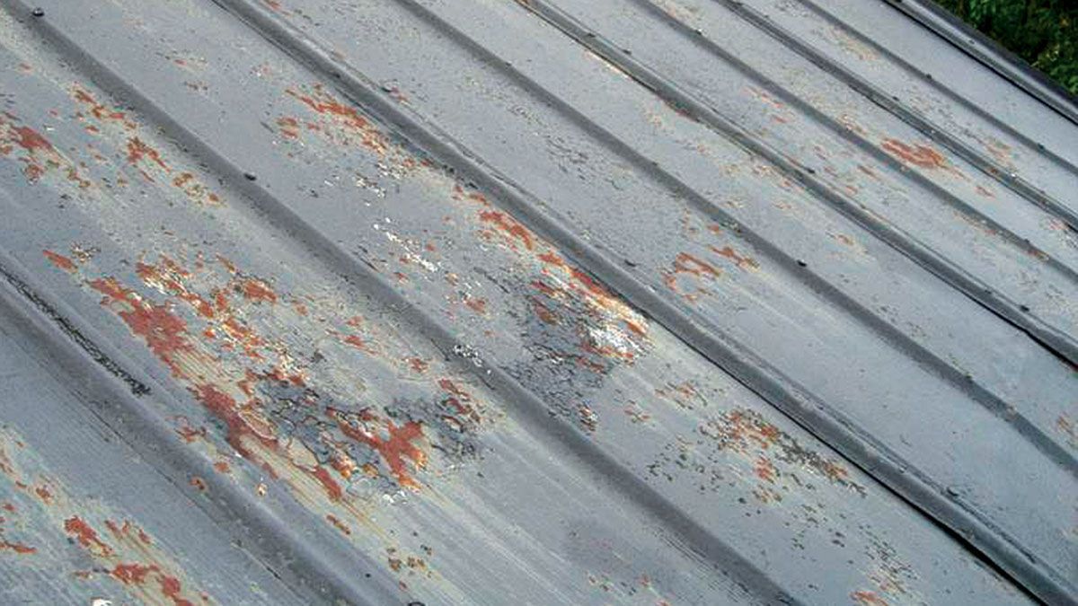 A close up of a rusty metal roof with a lot of rust on it.