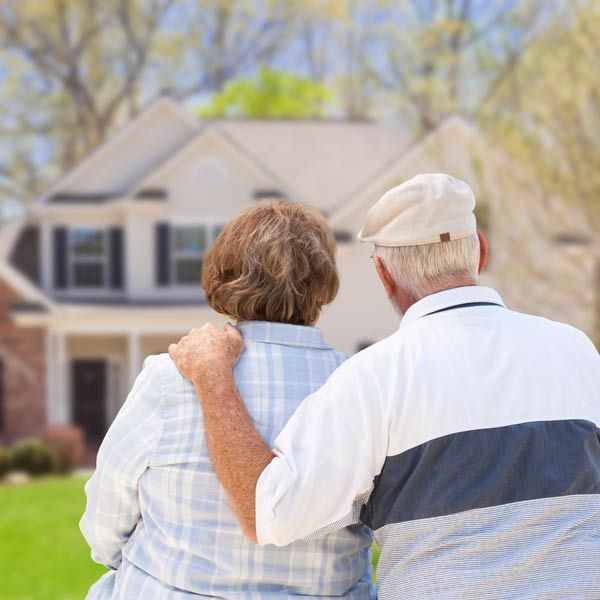 A man and a woman are looking at a house