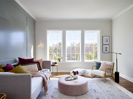 A living room with a couch , chair and ottoman