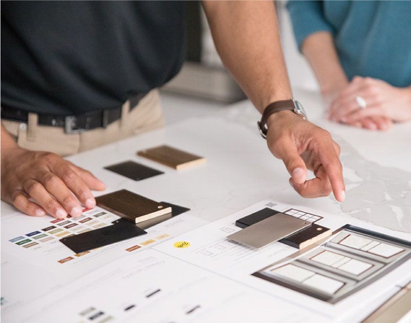 A man is pointing at a piece of paper on a table