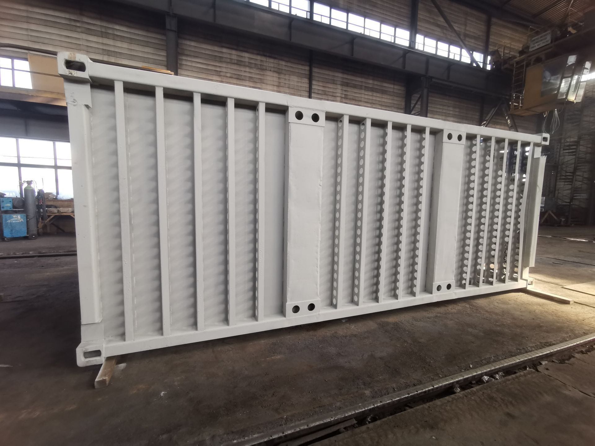 White shipping container in a warehouse setting.