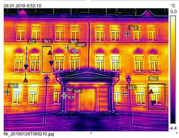 Thermal image of a building facade. Purple, orange, and yellow indicate temperature variations. Arrows and markers highlight areas.