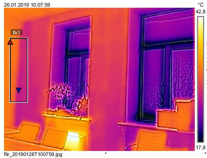 Thermal image of a room with two windows, showing temperature variations in purple, yellow, and orange.