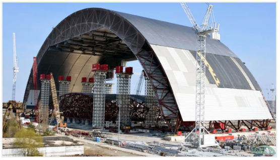 A large metal arch structure over the Chernobyl nuclear plant, covering the damaged reactor.