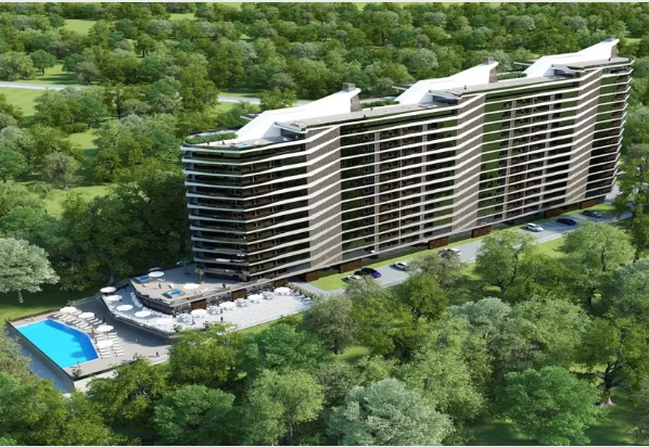 Modern multi-story building with balconies, near a pool and trees.