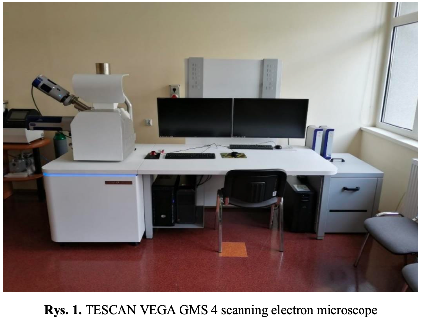 TESCAN VEGA GMS 4 scanning electron microscope in a lab setting, with dual monitors and computer setup.