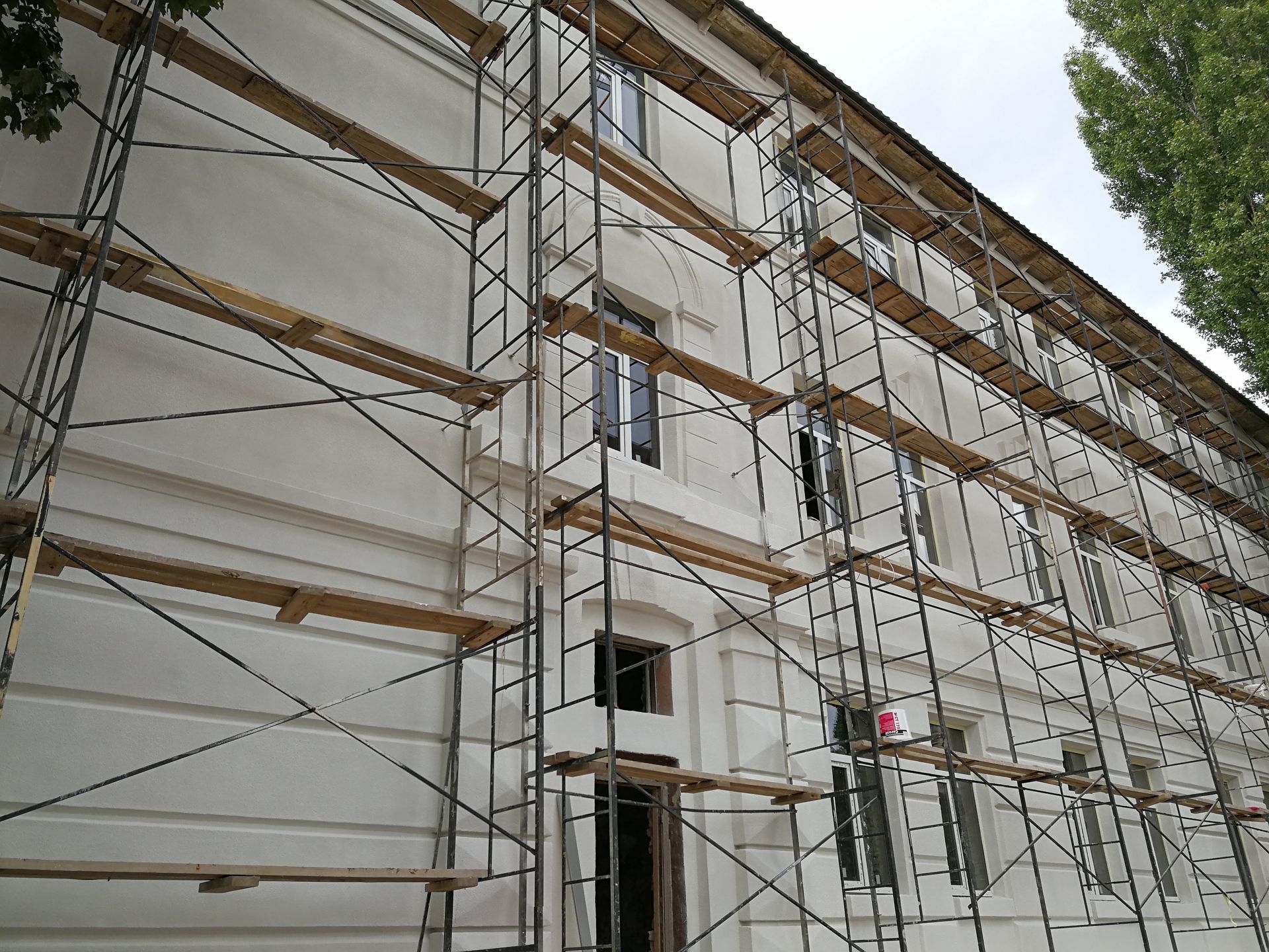Building facade covered in scaffolding, undergoing renovation.