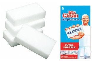 White magic eraser sponges beside Mr. Clean Extra Durable packaging on blue background