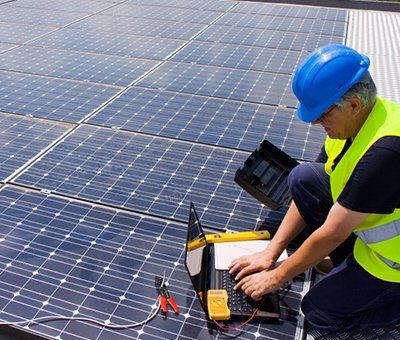 men installing solar panels on a roof